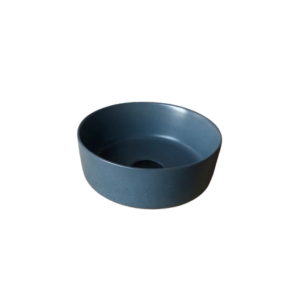 Mini Round Concrete basin in a deep blue ocean colour. With a black waste plug on a blank background.