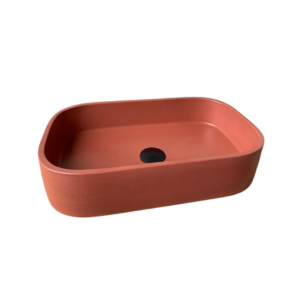 A stunning deep coral rectanglur concrete basin, featuring a black waste plug. On a plain background